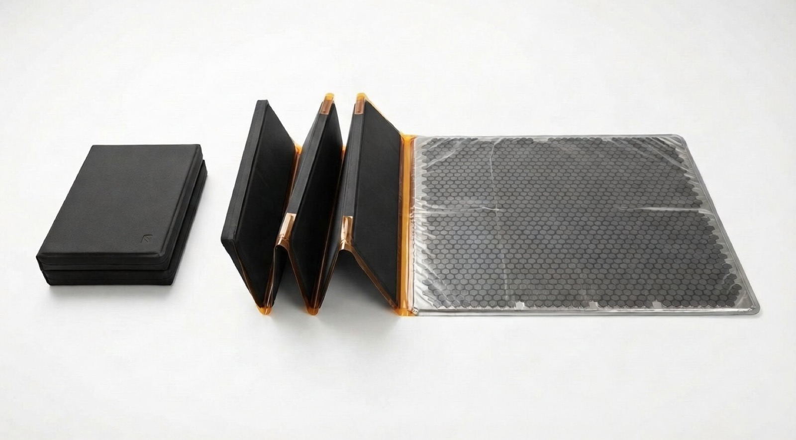 Accordion fold design showing three states: folded, partially unfolded, and fully deployed with hexagonal thermal cells
